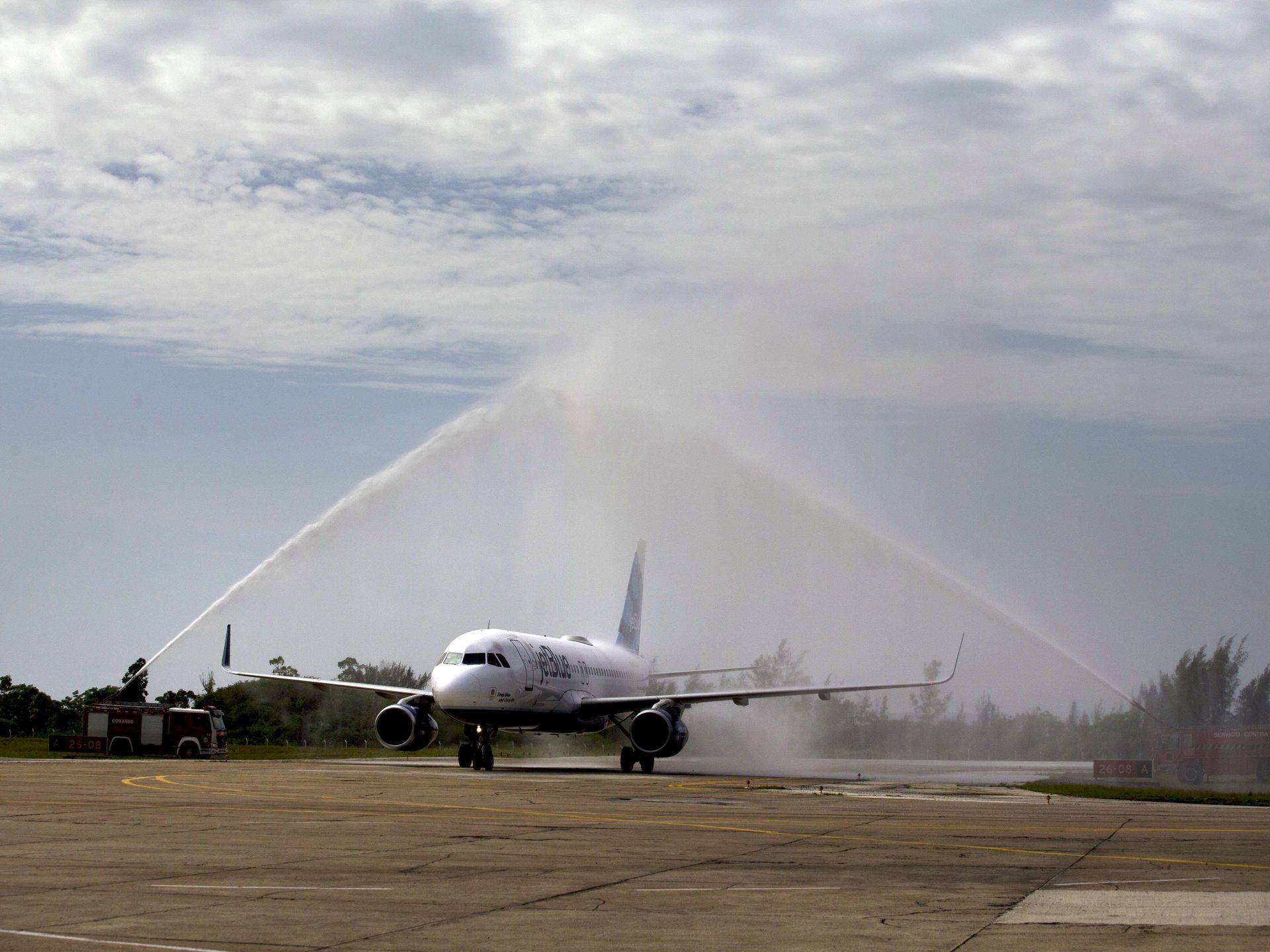 After landing in Santa Clara the JetBlue aeroplane received a ceremonial water canon shower from Cuban fire engines. Photo by USA Today.